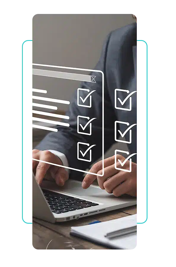Person in a suit typing on a laptop at a wooden desk for Propio HealthTrust quality control